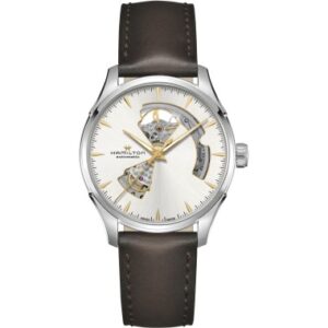Questa è l'immagine frontale dell'orologio hamilton jazzmaster open heart con quadrante argrnto e indici dorati. L'orologio presenta un movimento automatico e un bracciale in pelle